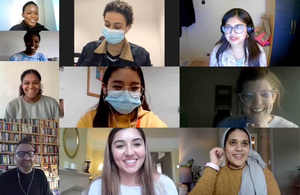 students and mentors on a video call looking happy